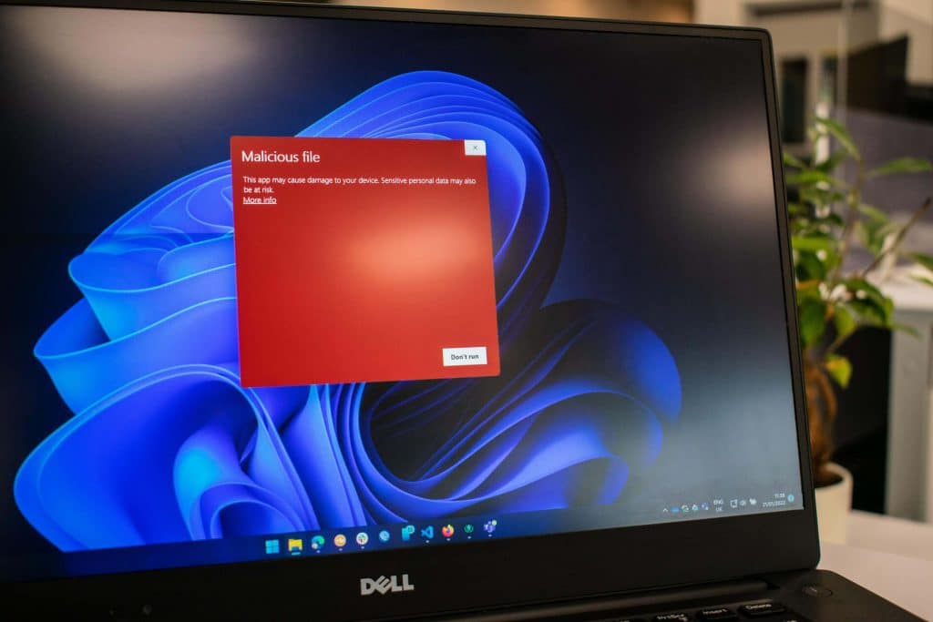 red block on screen with text malicious file, showing an example of malware software